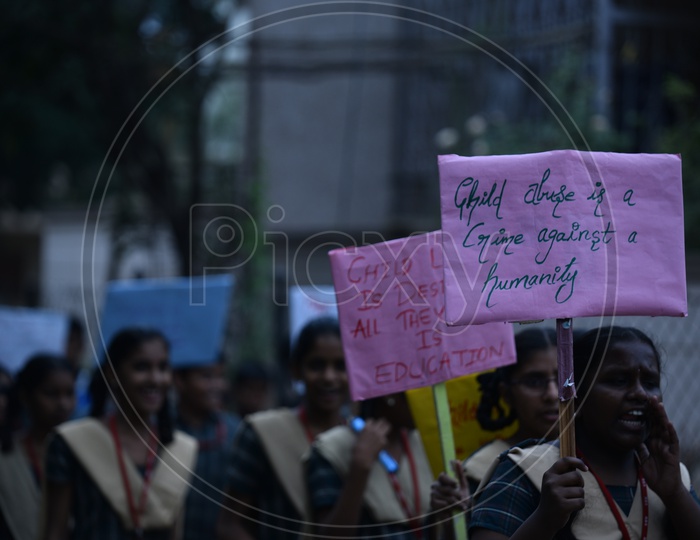 School Children Holding Placards  In a Road Rally Against Child Abuse