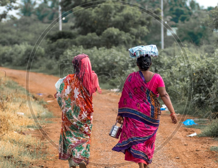 Two women walking in the fields