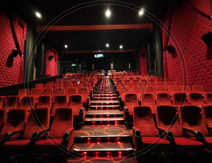 Empty Movie Theater Auditorium With Red Seats in Rows