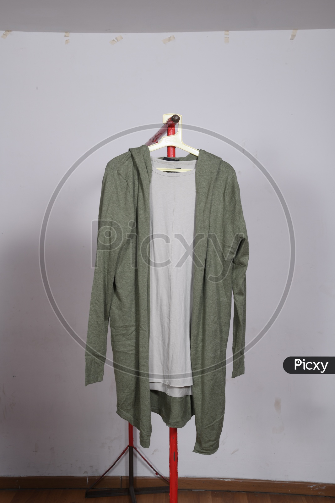 Designer Costumes Tshirt And Jacket   Display By Hanging To Hangers Over Isolated Background
