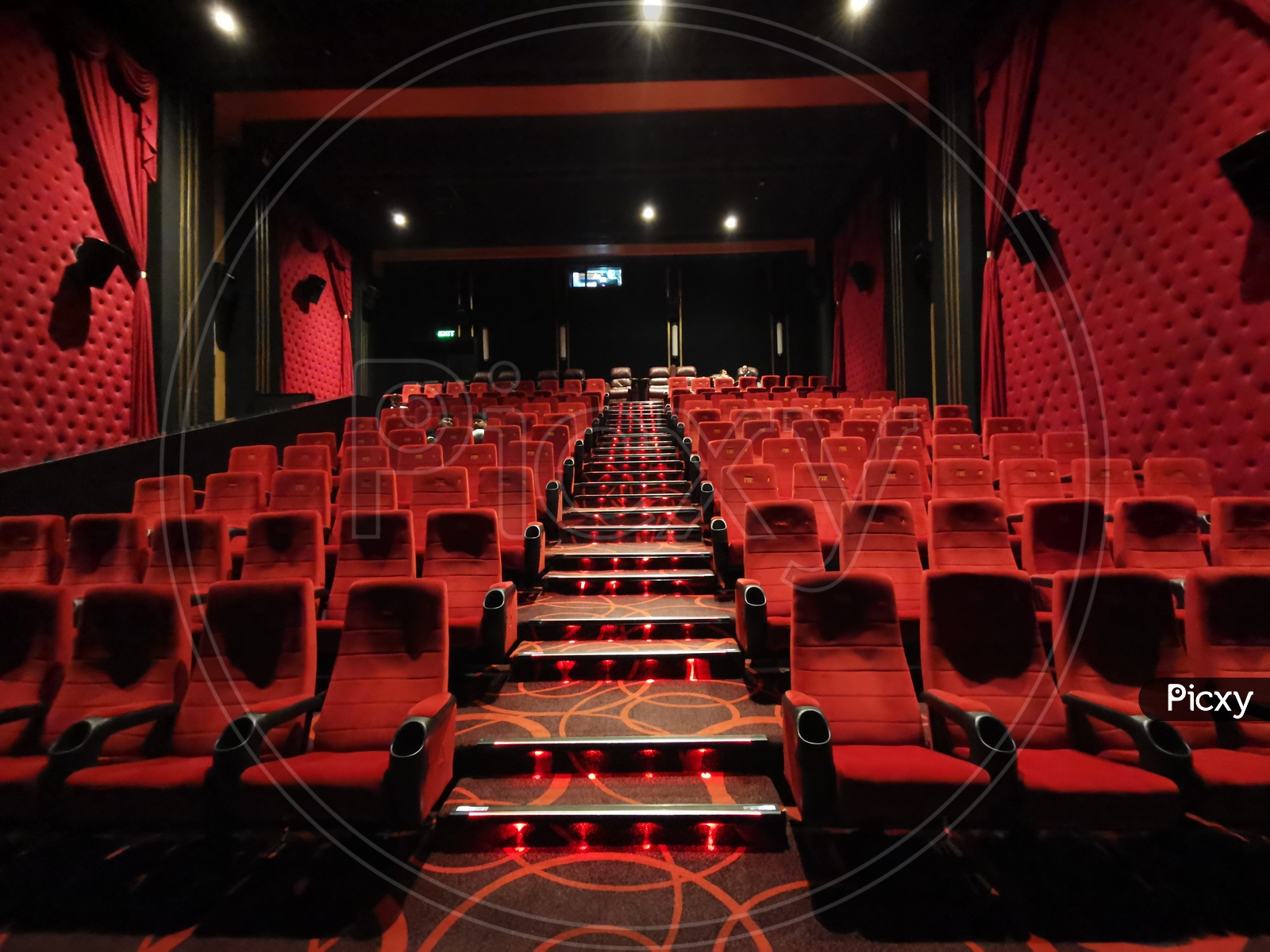 Empty Movie Theater Auditorium With Red Seats in Rows