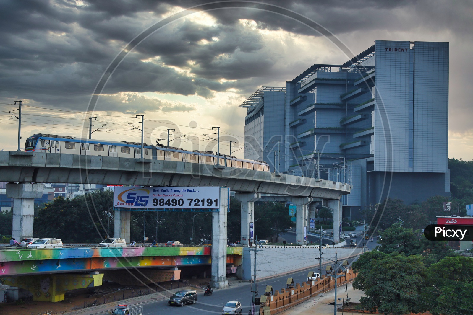 Hyderabad Metro Train With trident Hotel In Background