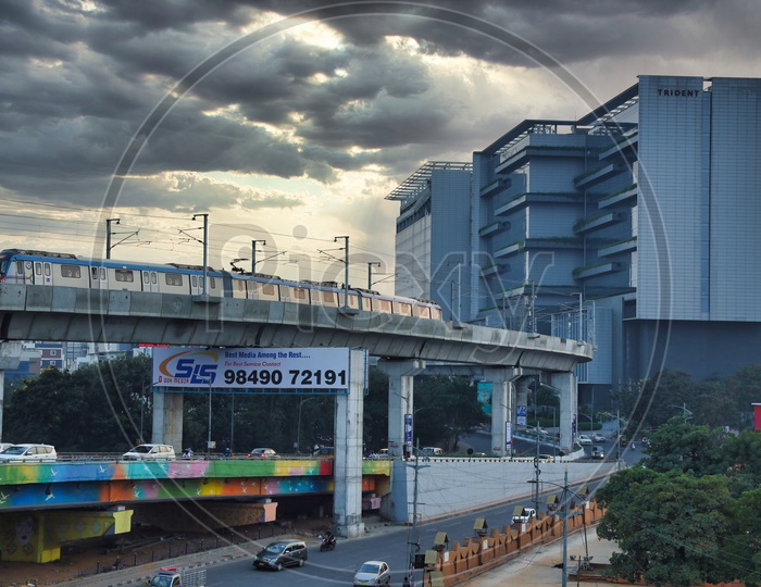 Hyderabad Metro Train With trident Hotel In Background