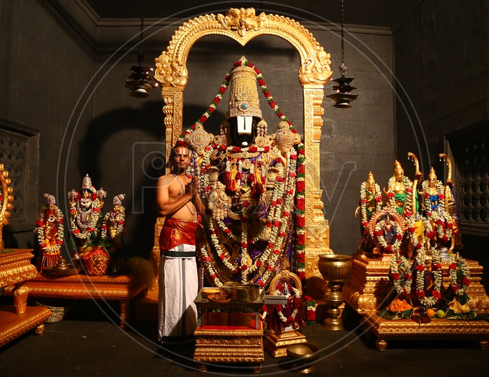 Indian Hindu Priest Performing Pooja to  Lord Venkateshwara Swamy Idol in an Temple