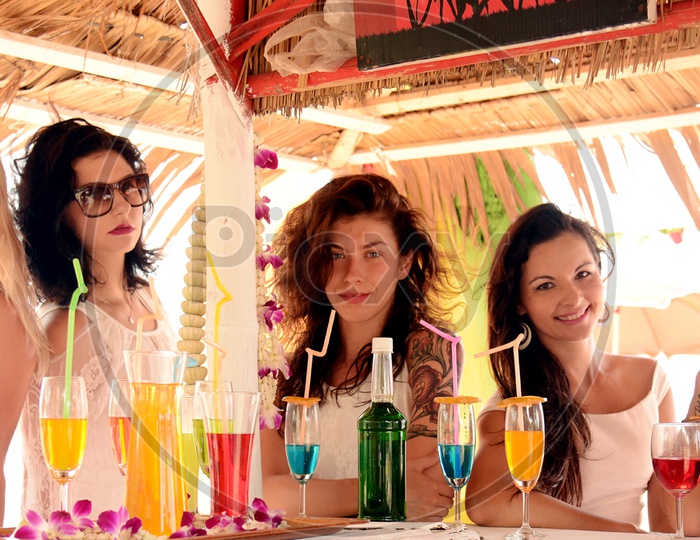 Russian Girls At a Bar Counter With Cocktail Glasses