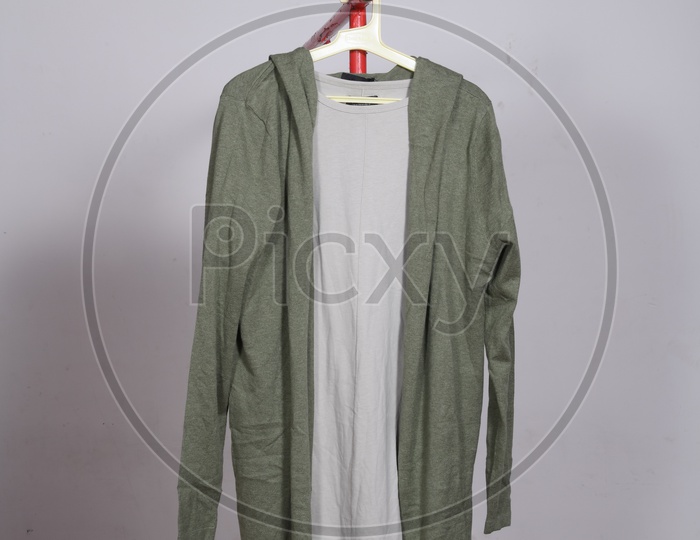 Designer Costumes Tshirt And Jacket   Display By Hanging To Hangers Over Isolated Background