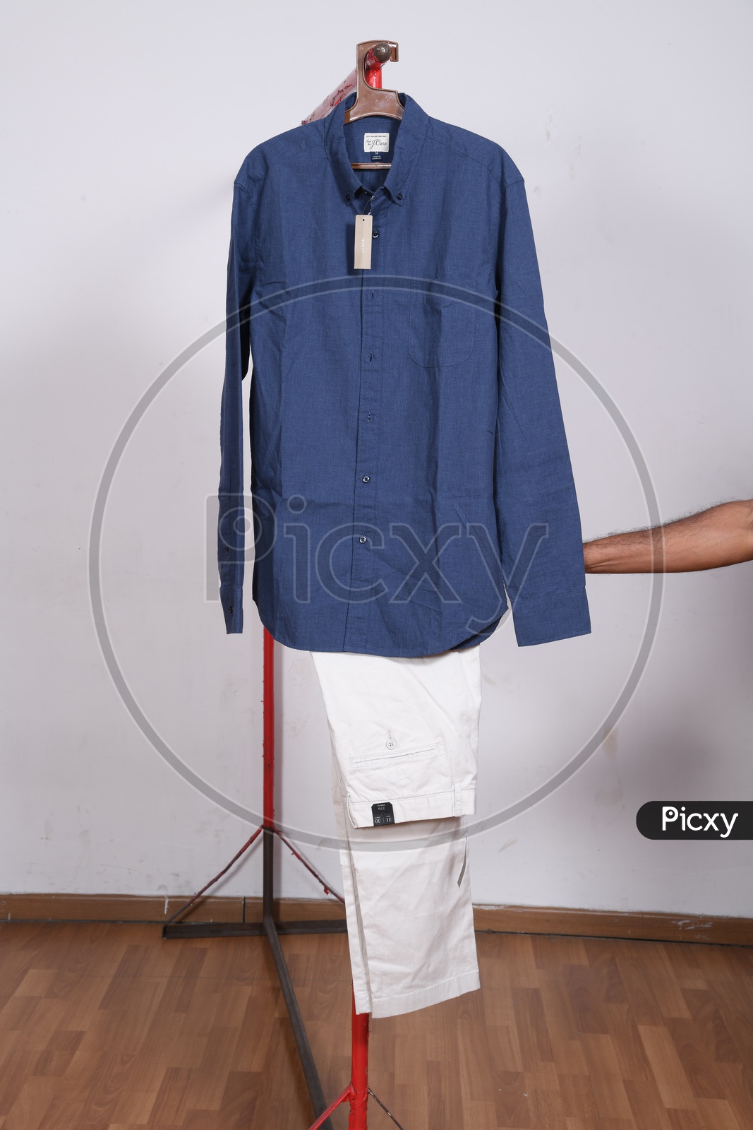 Designer Costumes Shirt And Trouser  Display By Hanging To Hangers Over Isolated Background