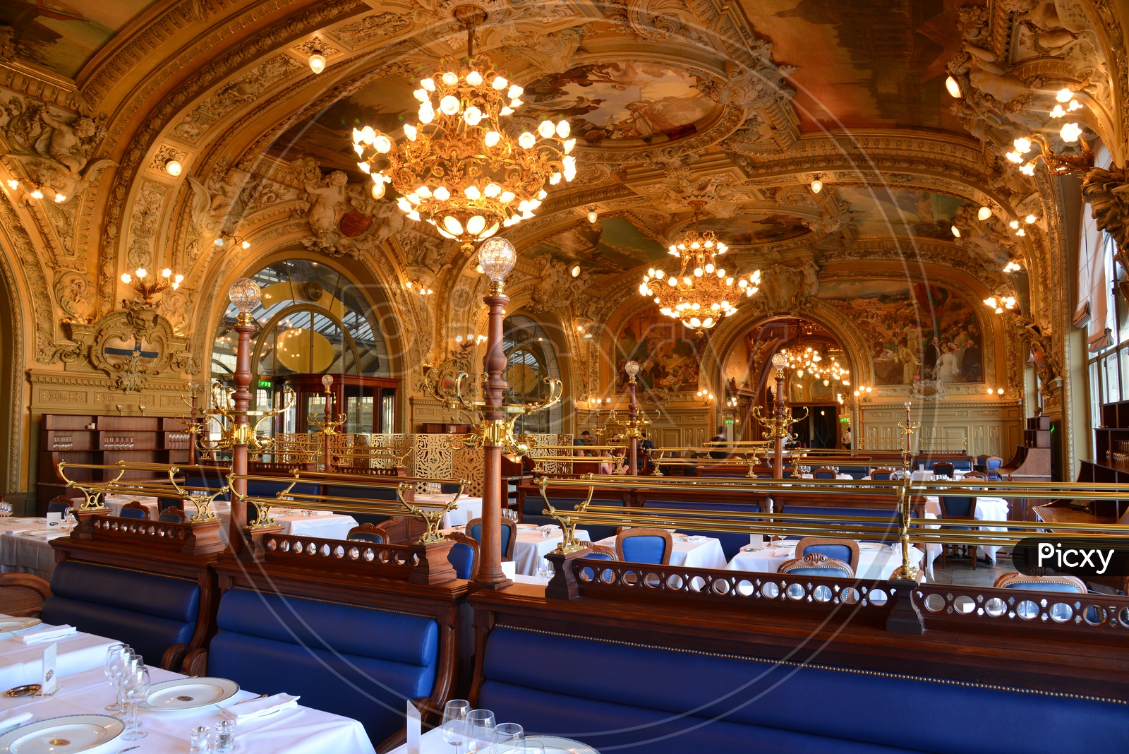 Interior of Grand Palace Hotel With Dining Tables And Chandeliers