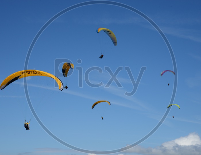 Para gliders  Flying in Air With Blue Sky as Background
