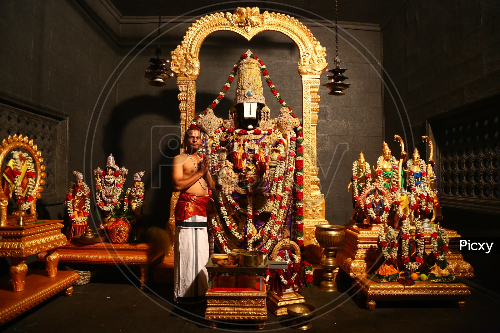 Indian Hindu Priest Performing Pooja to  Lord Venkateshwara Swamy Idol in an Temple