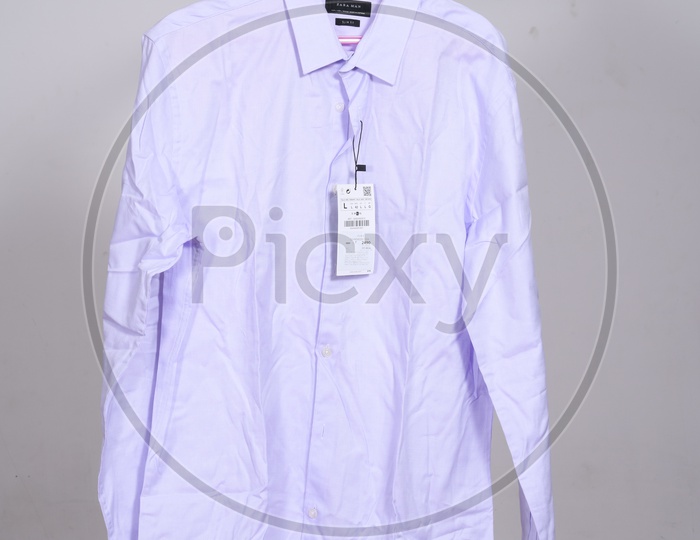 Designer Costumes Shirt And Trouser  Display By Hanging To Hangers Over Isolated Background
