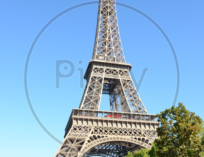 Eiffel Tower View With Lawn Garden And Sky As Background