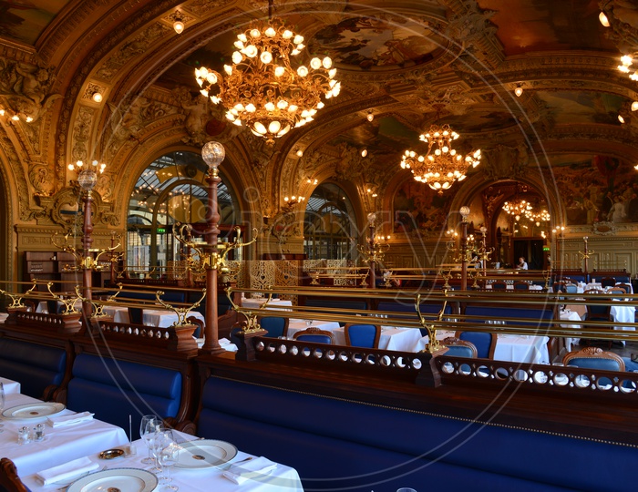 Interior of Grand Palace Hotel With Dining Tables And Chandeliers