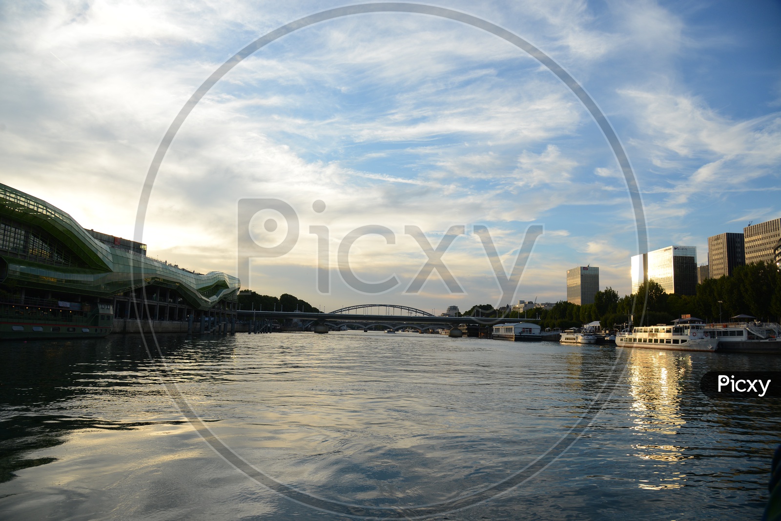 River Seine Channel With Stone Arch Bridge In Paris