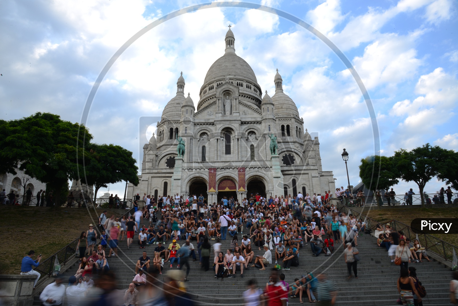 Sacré-Cœur Basilica , Also Called As The Basilica of the Sacred Heart of Paris A Roman Catholic Church In Paris With  Busy Visitors Sitting on Steps