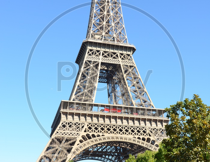 Eiffel Tower View With Lawn Garden And Sky As Background