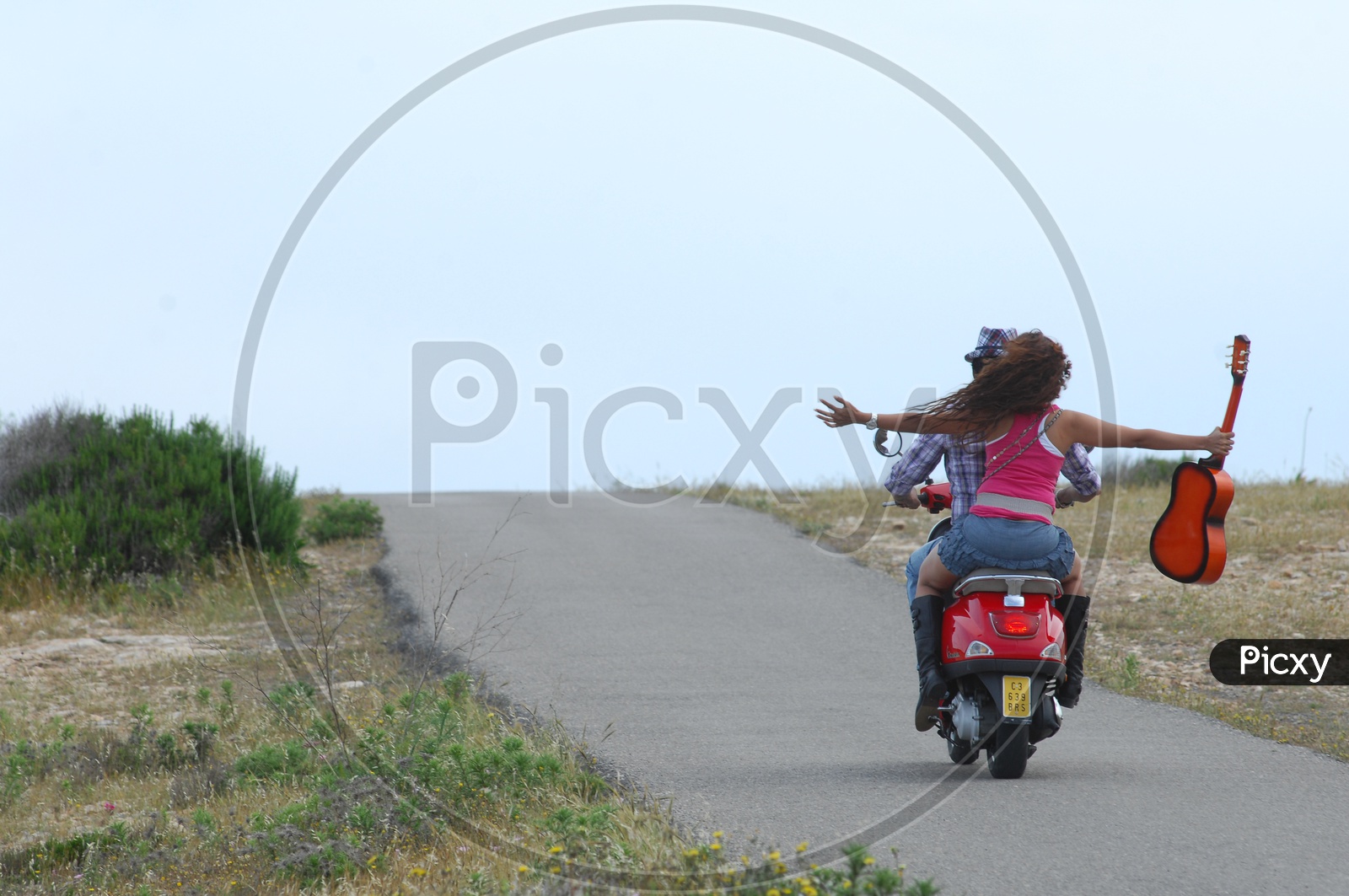 Couple Enjoying Bike Ride In Lone Road