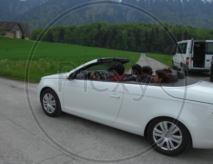 People Travelling in Car On Swiss Alps