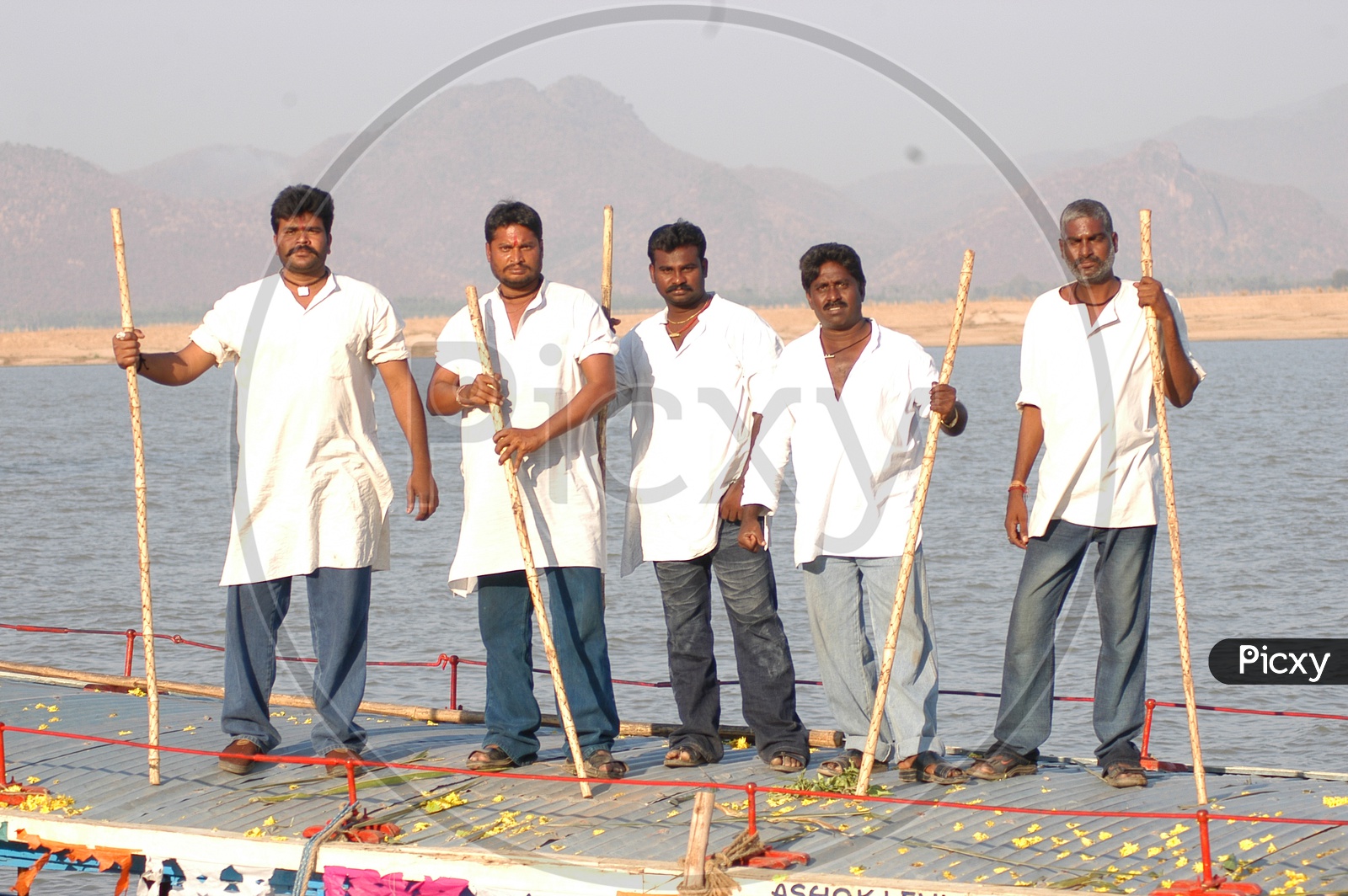 A Group Of Goons With Wooden Sticks In Hand in Movie Working Stills