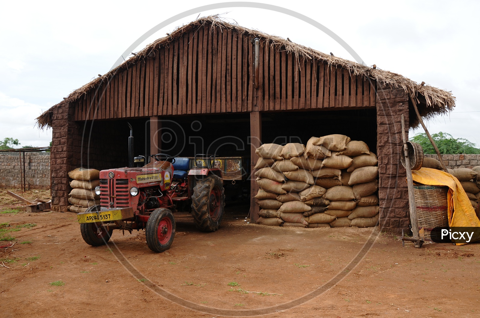 Paddy Storage Shelter With Paddy Bags And Tractor  in Rural Village Houses