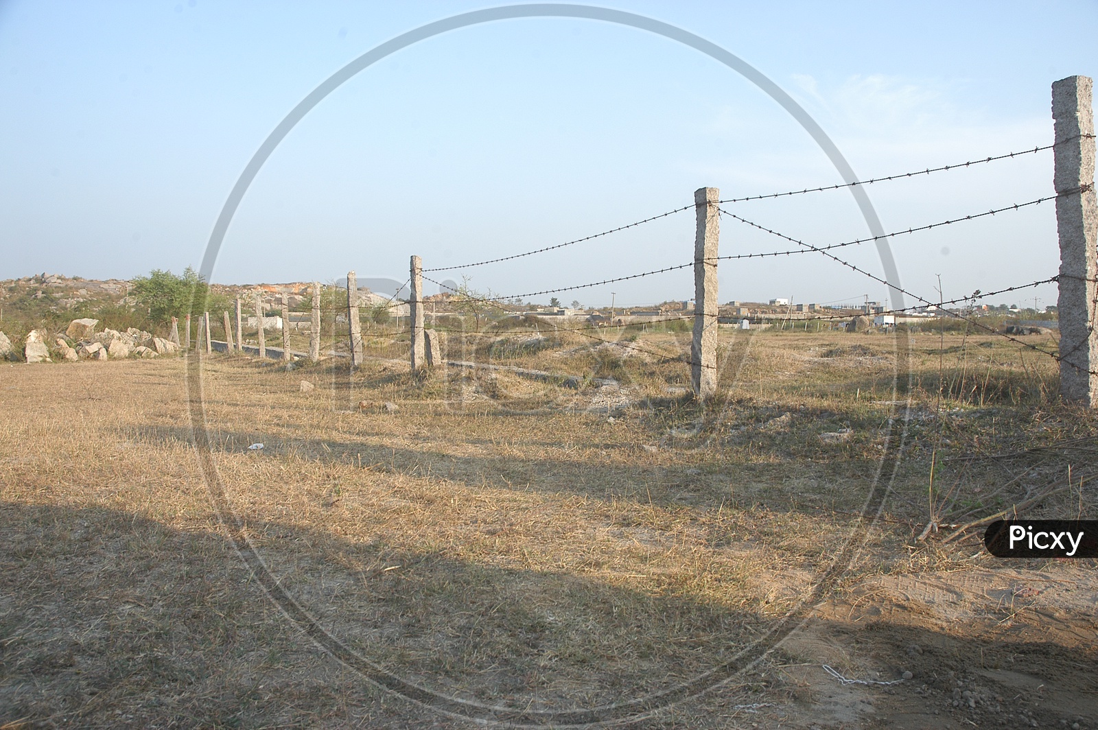 Barren Land With Metal Wore Fence