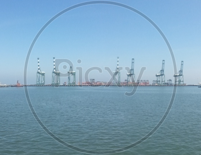 Panoramic View Of a Harbor With Ships And Heavy Cranes