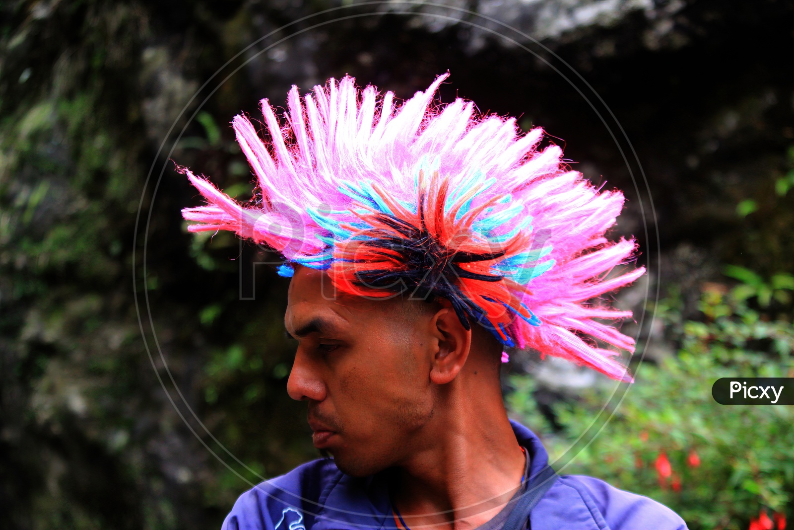 Side Portrait Of A Tribal Hippie Wearing Pink Head Gear With Mohawk Hair Style