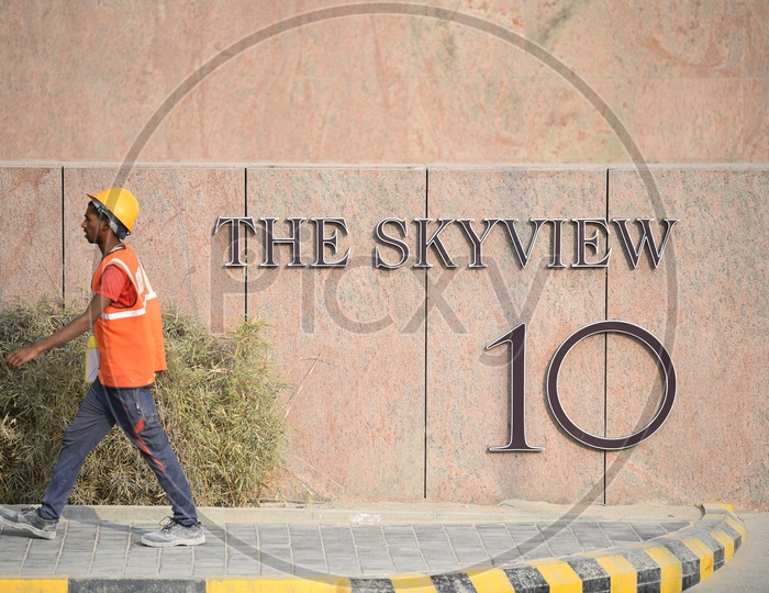 A Construction Worker walking on Footpath at THE SKYVIEW 10, Hyderabad