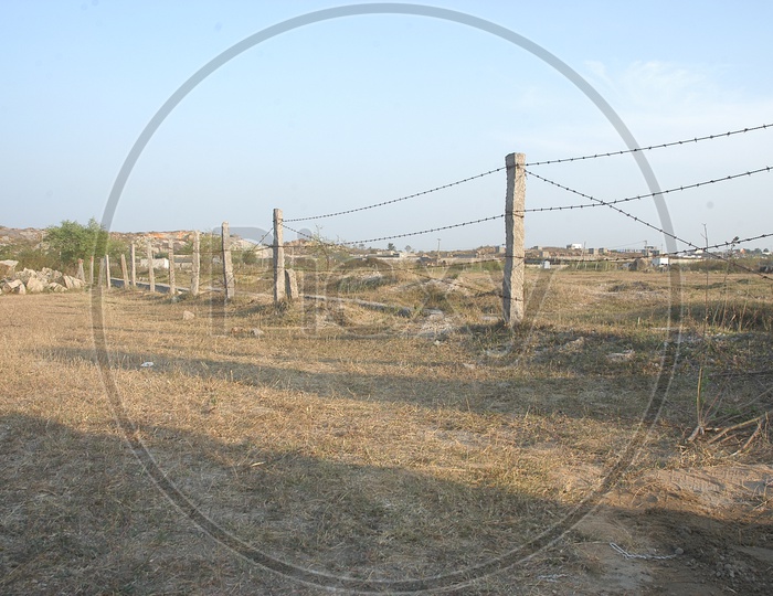 Barren Land With Metal Wore Fence