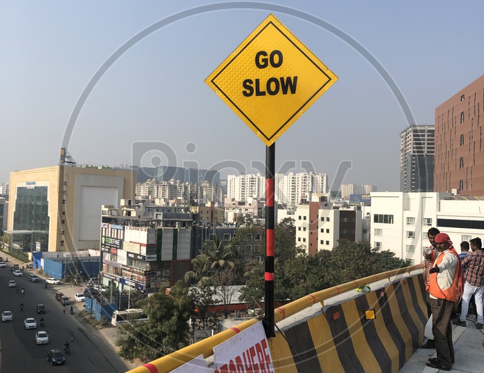 Go Slow Caution Traffic Sign Board on Biodiversity Flyover