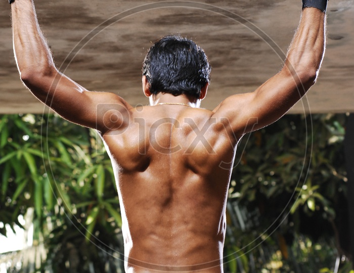 Young Indian Man with Six Pack doing Exercise
