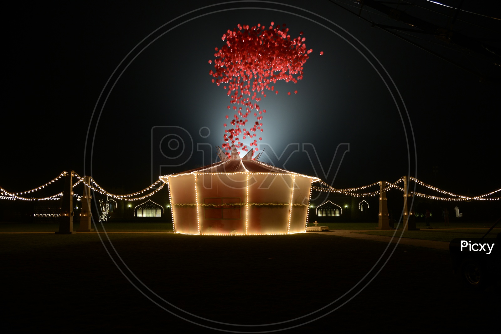 A Tent With Led Light Decoration And Red Gas Balloons in Night Backdrop