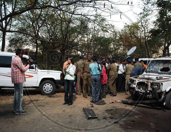 Police officers and Forensic Department Inspecting the Car Bomb Blast Spot