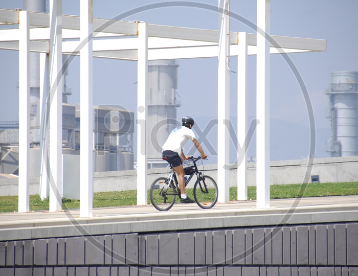 A Cyclist Riding Bicycle On Pathway