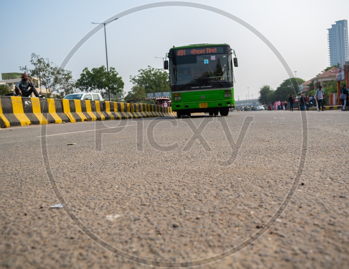 DTC bus taking turn and passengers waiting at bus stop