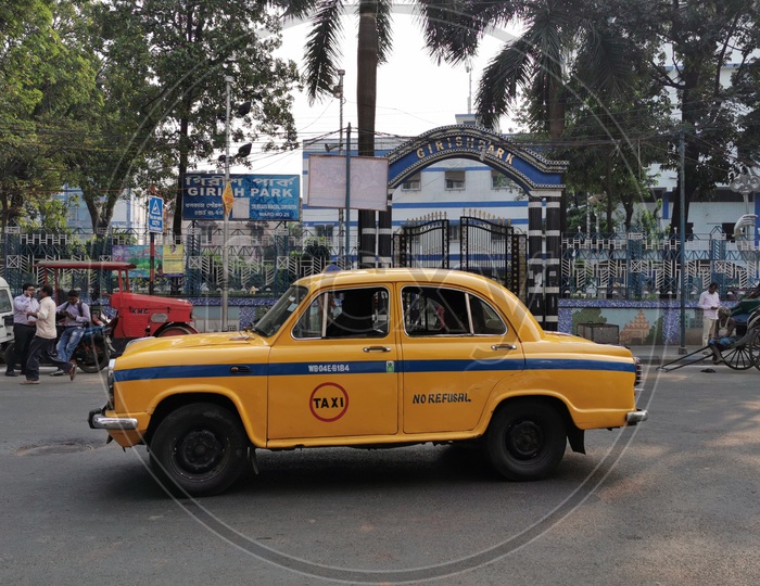 Yellow Taxi On Roads of Kolkata With Girish Park MMTS  Station  In Background