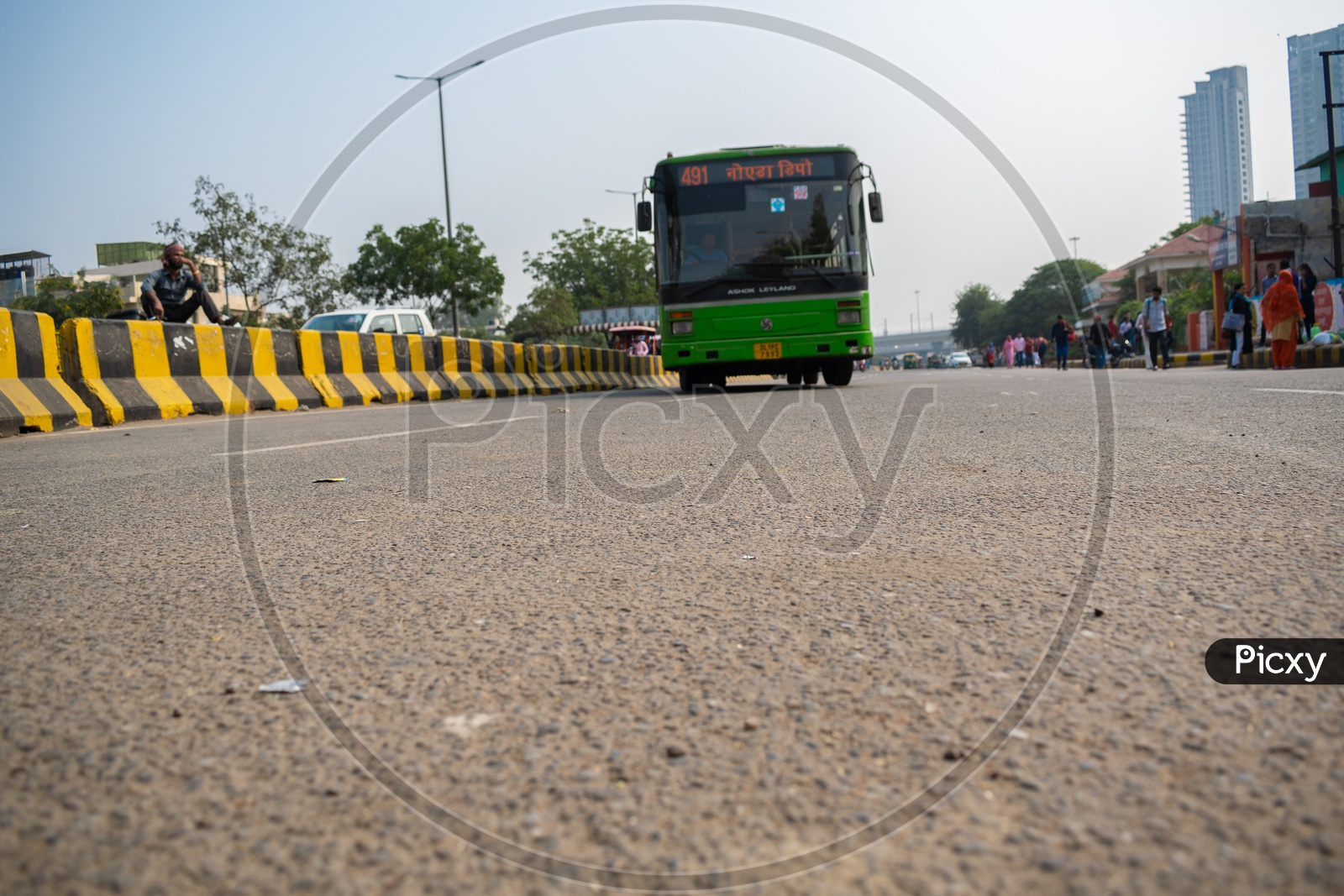 DTC bus taking turn and passengers waiting at bus stop