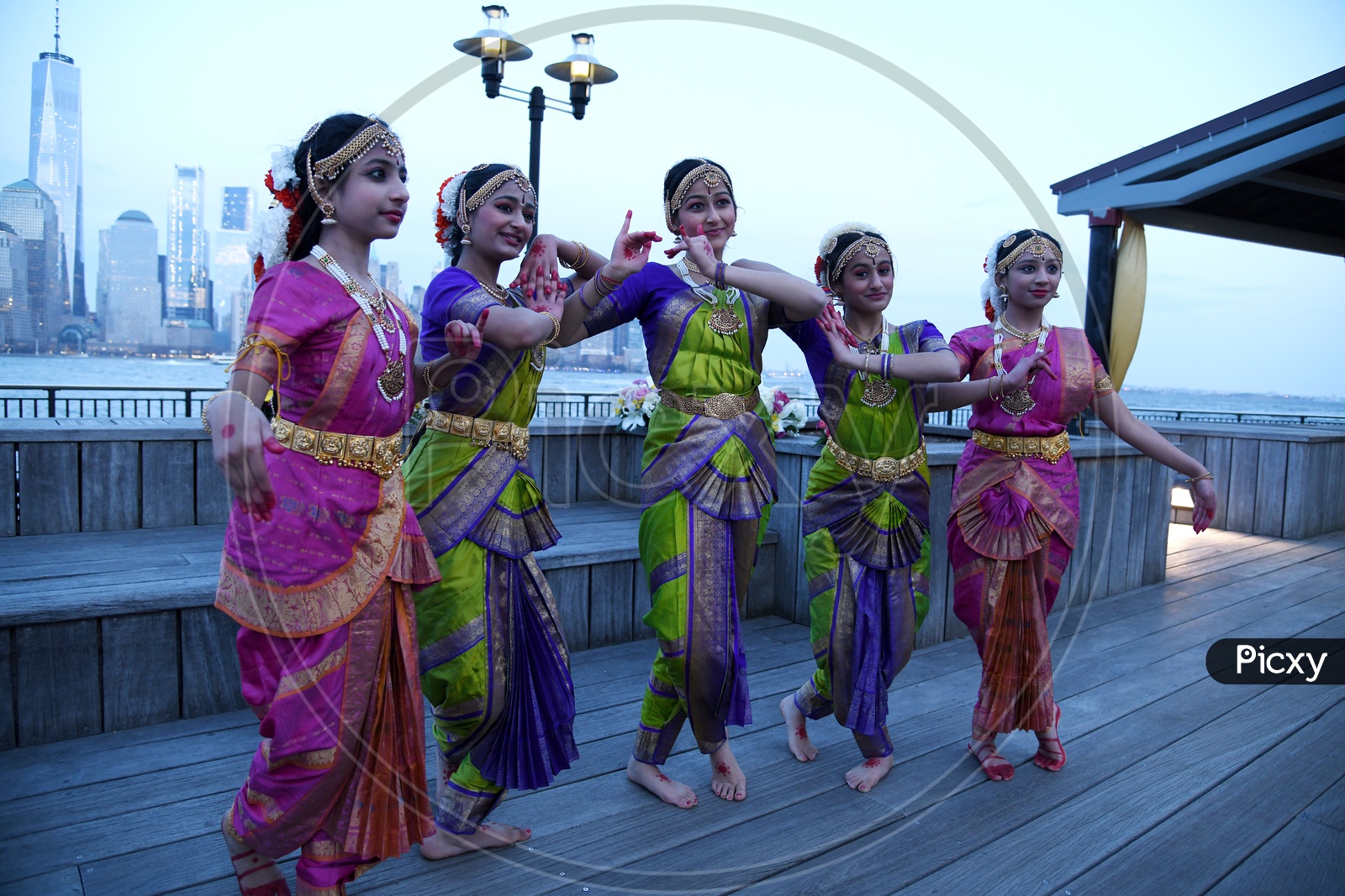 Indian Classical Dancers  On Eastern River Bank In New York With High Rise Building Blocks In Background