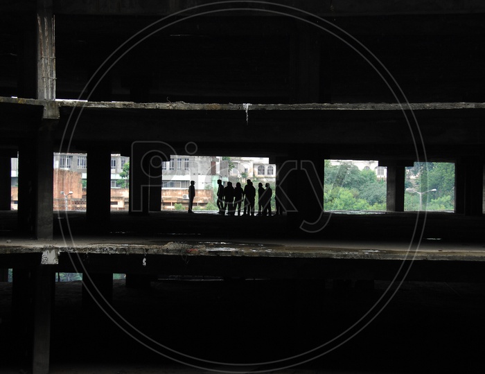 Silhouette Of Group Of People Meeting In an Under Construction Building