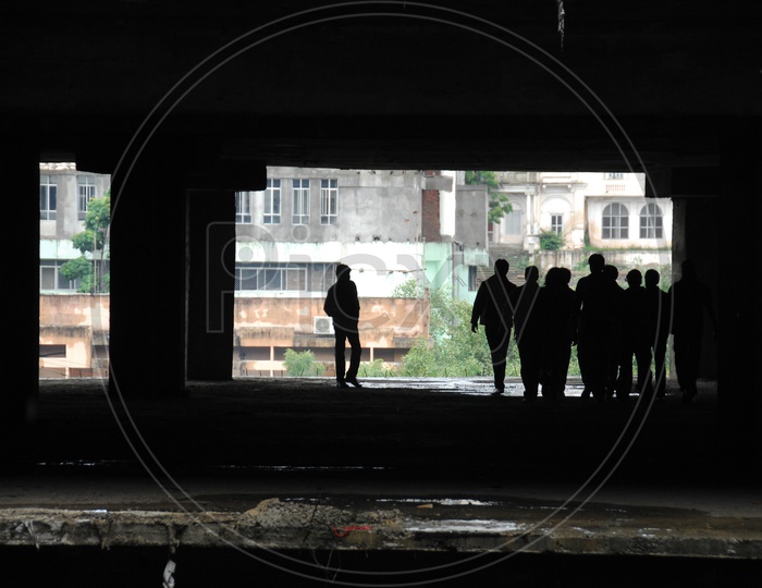 Silhouette Of Group Of People Meeting In an Under Construction Building