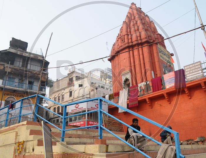 Ghats In Varanasi With Hindu  Temples And Boats on Ganga River