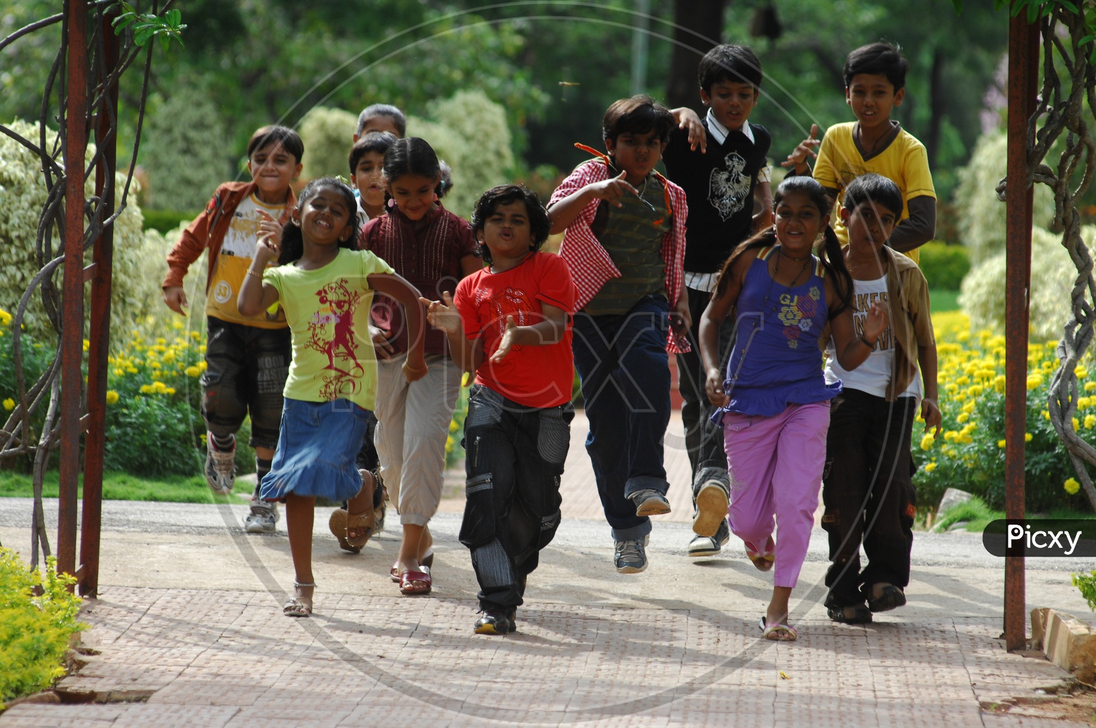 Group Of Children Happily Running in  a Park In Movie Working Stills