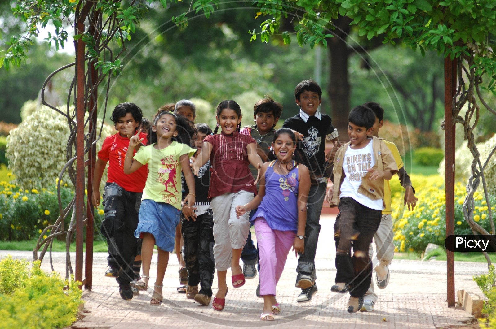 Group Of Children Happily Running in  a Park In Movie Working Stills