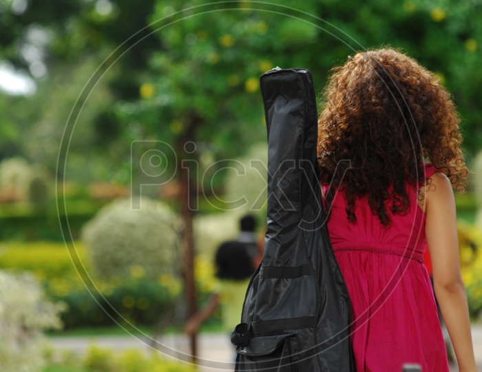 Modern Girl With Guitar To Her Shoulder