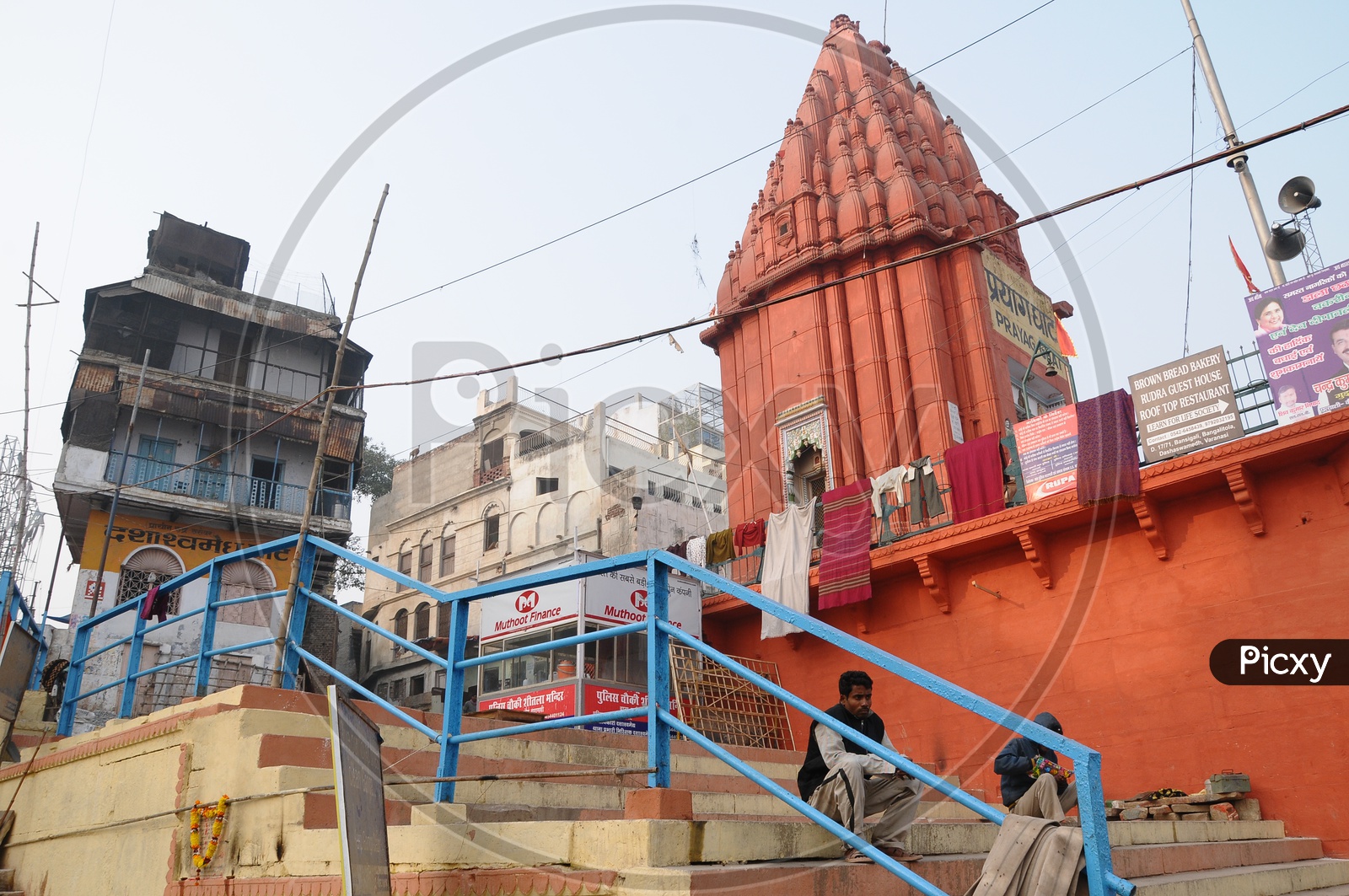 Ghats In Varanasi With Hindu  Temples And Boats on Ganga River