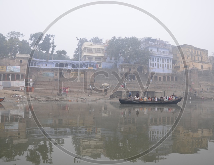 Ghats i  Varanasi in Morning Fog And Boats on River Godavari