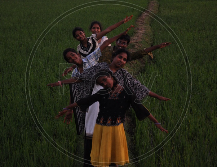 Children playing in paddy fields during Sankranthi festival