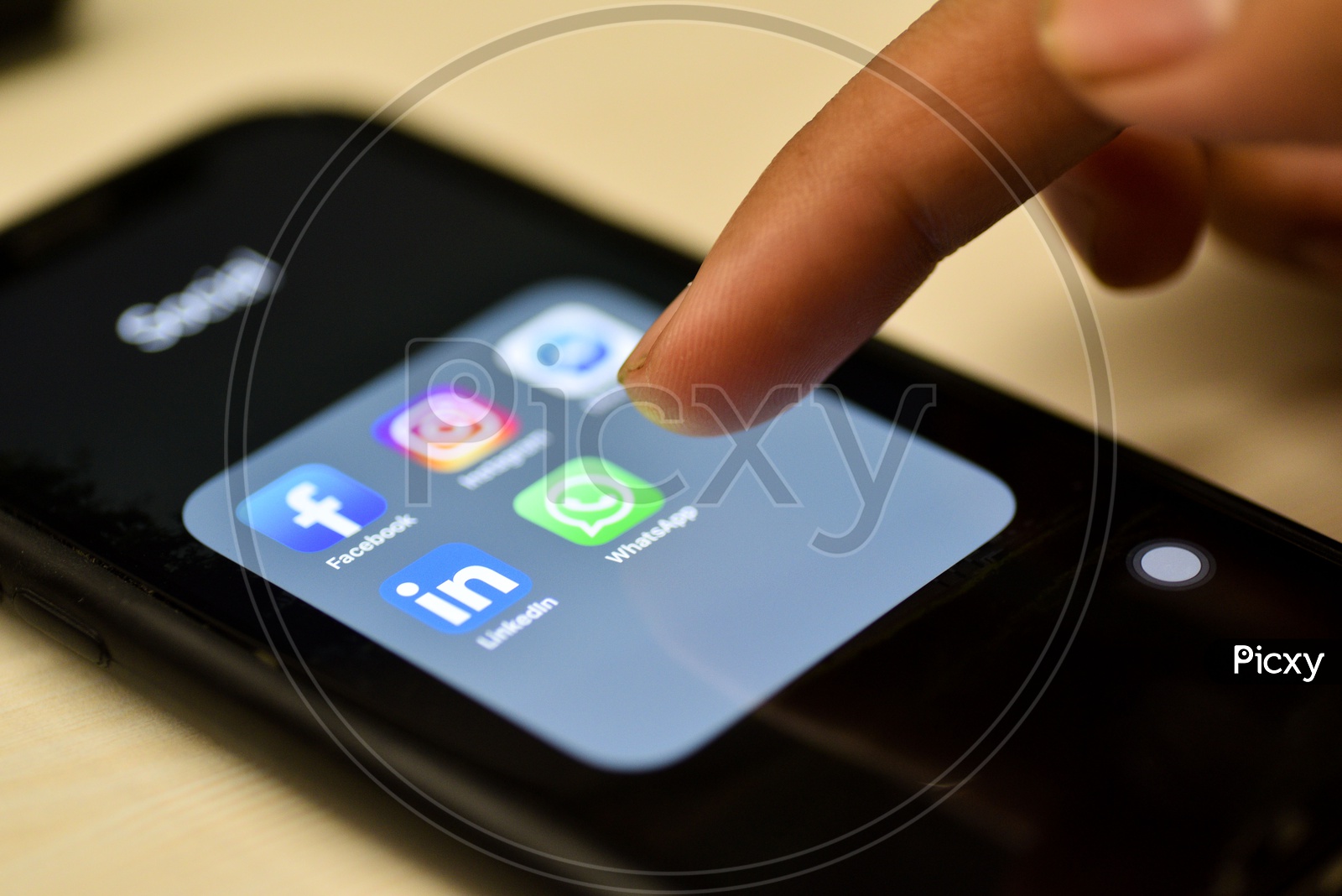Social Network Apps On a Smartphone Screen Closeup With Man Finger On Whatsapp