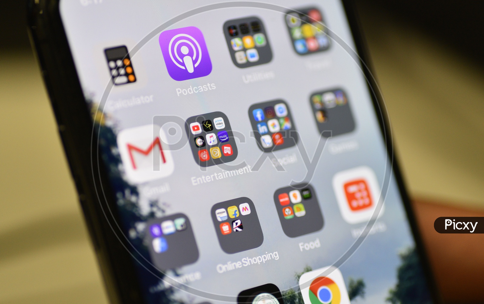 Installed Mobile Apps  or Applications Icons Arranged In an Organised  Way In Folders On Smartphone Screen With Selective Focus