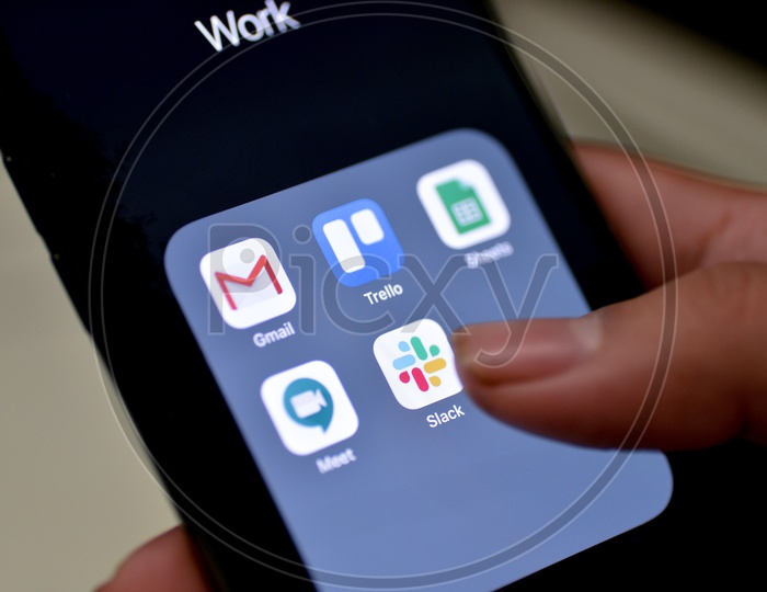 Man Finger Opening Slack  App On Smartphone Screen Closeup